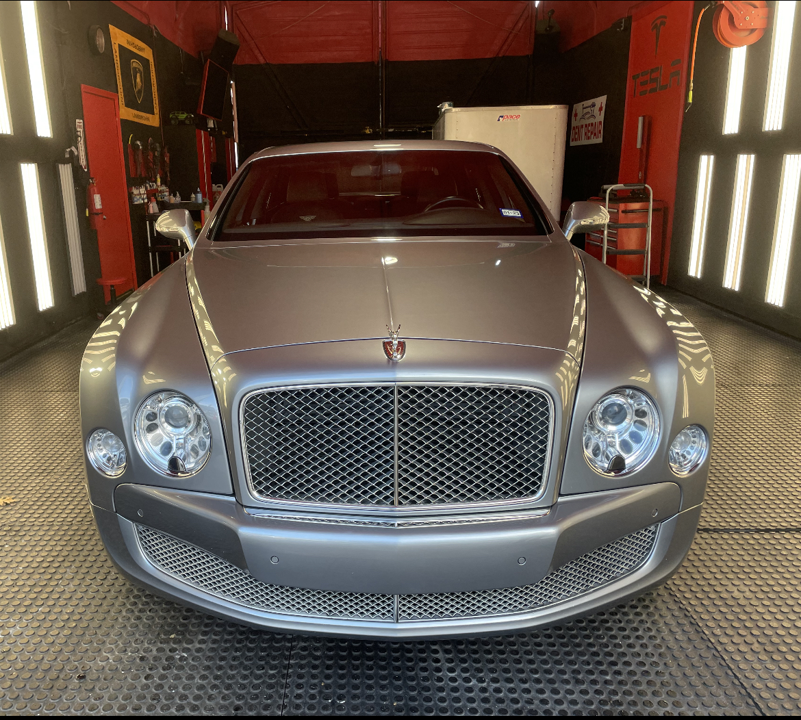 A silver Bentley Mulsanne head-on in the detail bay